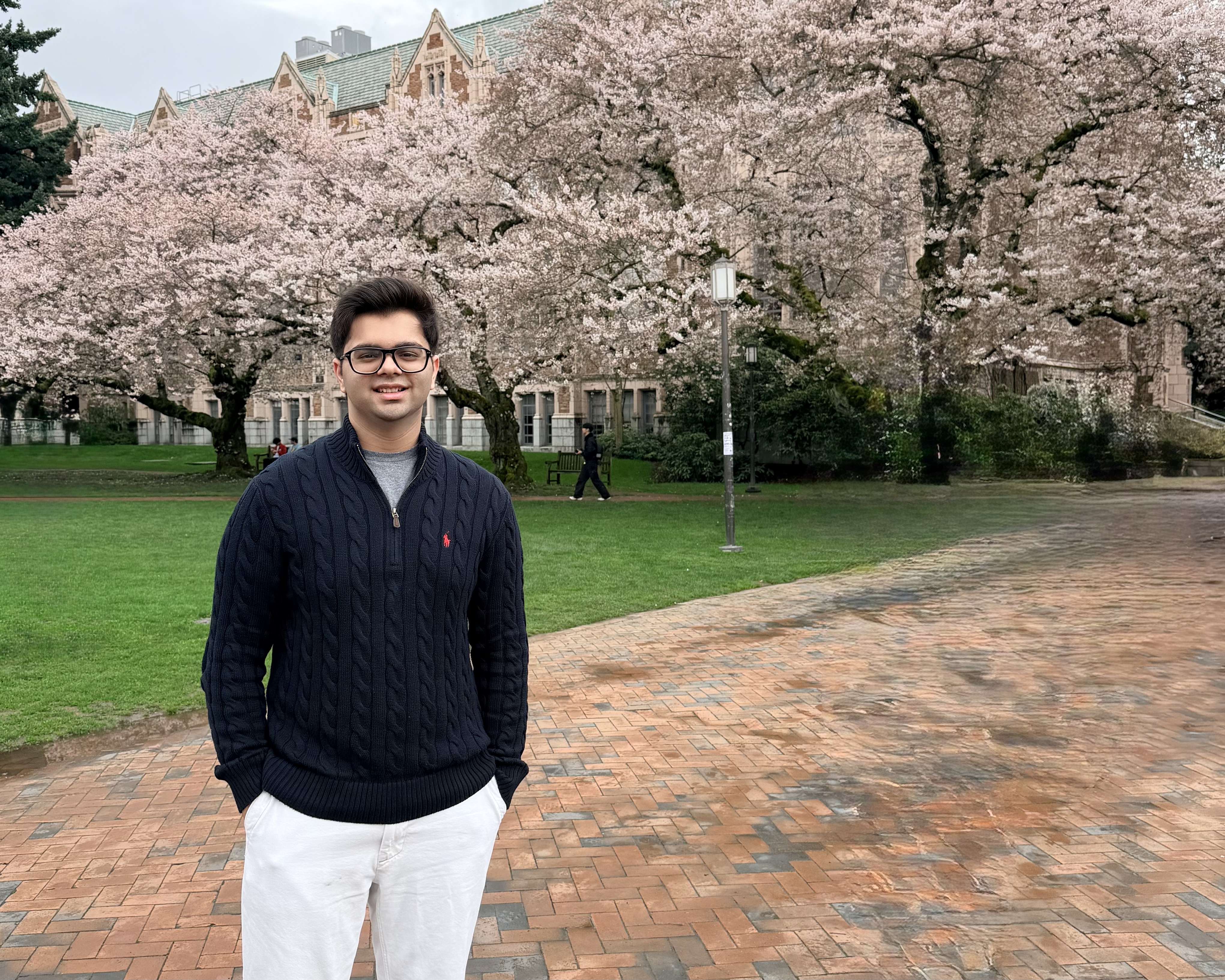 Aarav Chhabra on the University of Washington quad under cherry blossoms